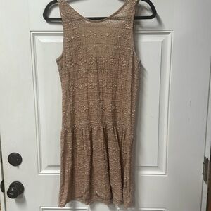 Large buff/muted pink sleeveless mini dress made of a stretchy lace